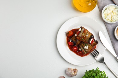 Tasty eggplant rolls served on white table, flat lay. Space for text