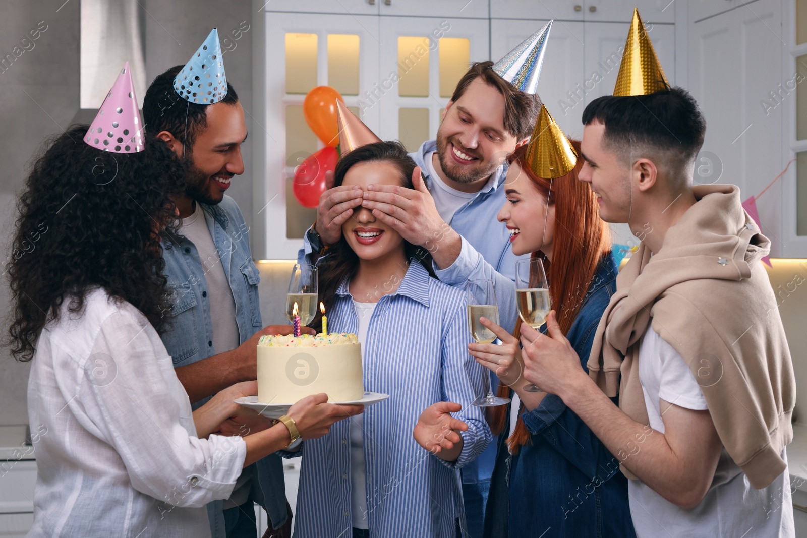 Photo of Happy friends with tasty cake celebrating birthday indoors