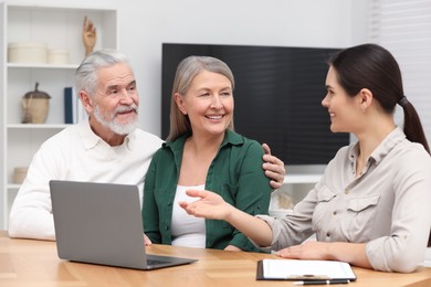 Notary consulting senior couple about Last Will and Testament in office