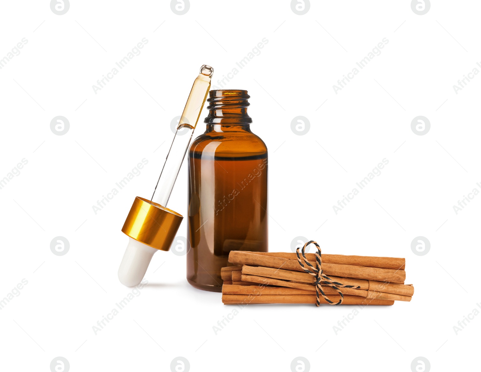 Image of Bottle of natural essential oil and dry cinnamon sticks on white background