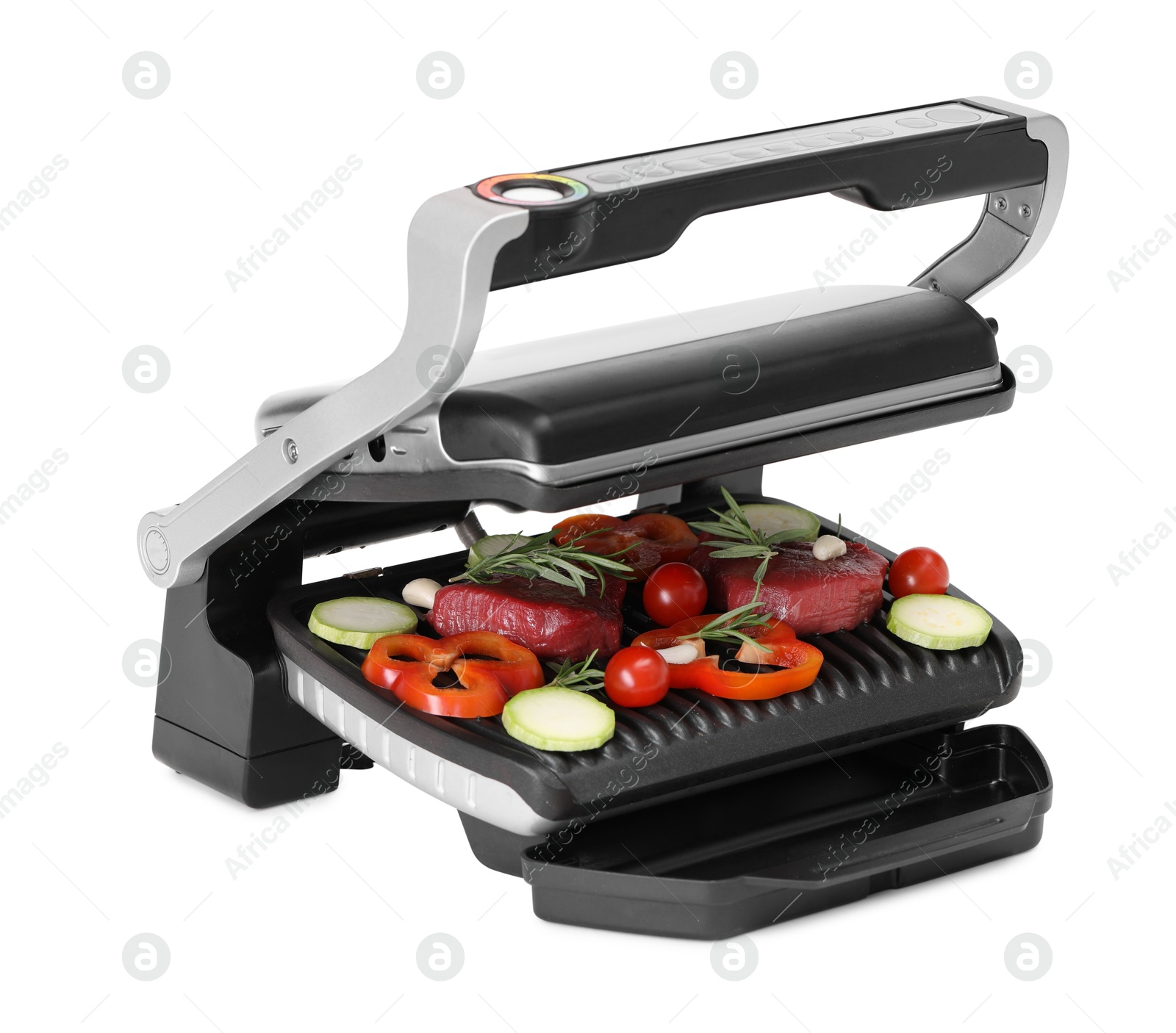 Photo of Electric grill with raw meat, rosemary and vegetables isolated on white