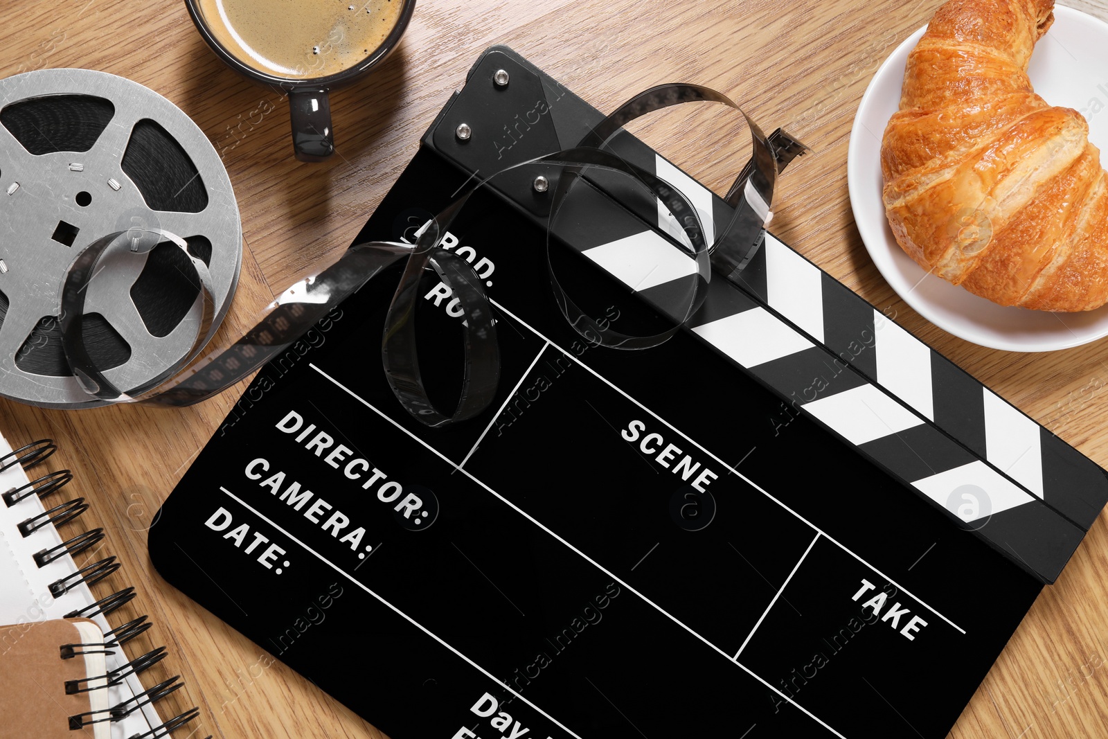 Photo of Flat lay composition with movie clapper on wooden table