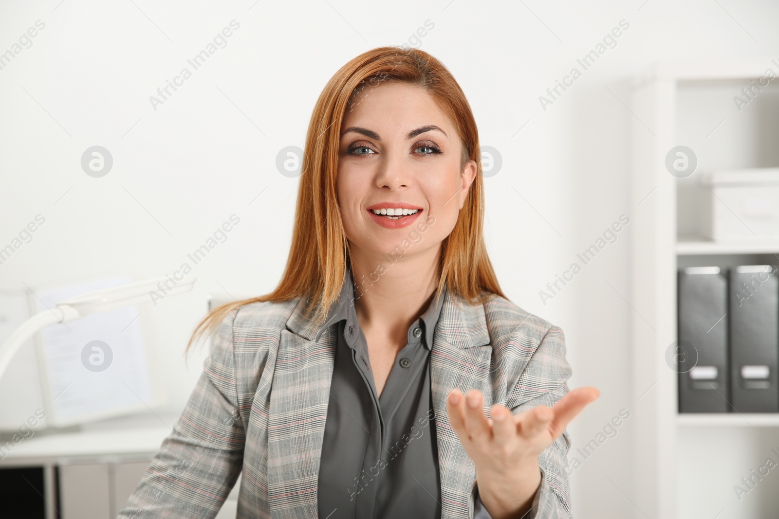 Photo of Happy woman using video chat in modern office, view from web camera