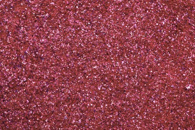 Photo of Beautiful pink shiny glitter as background, top view