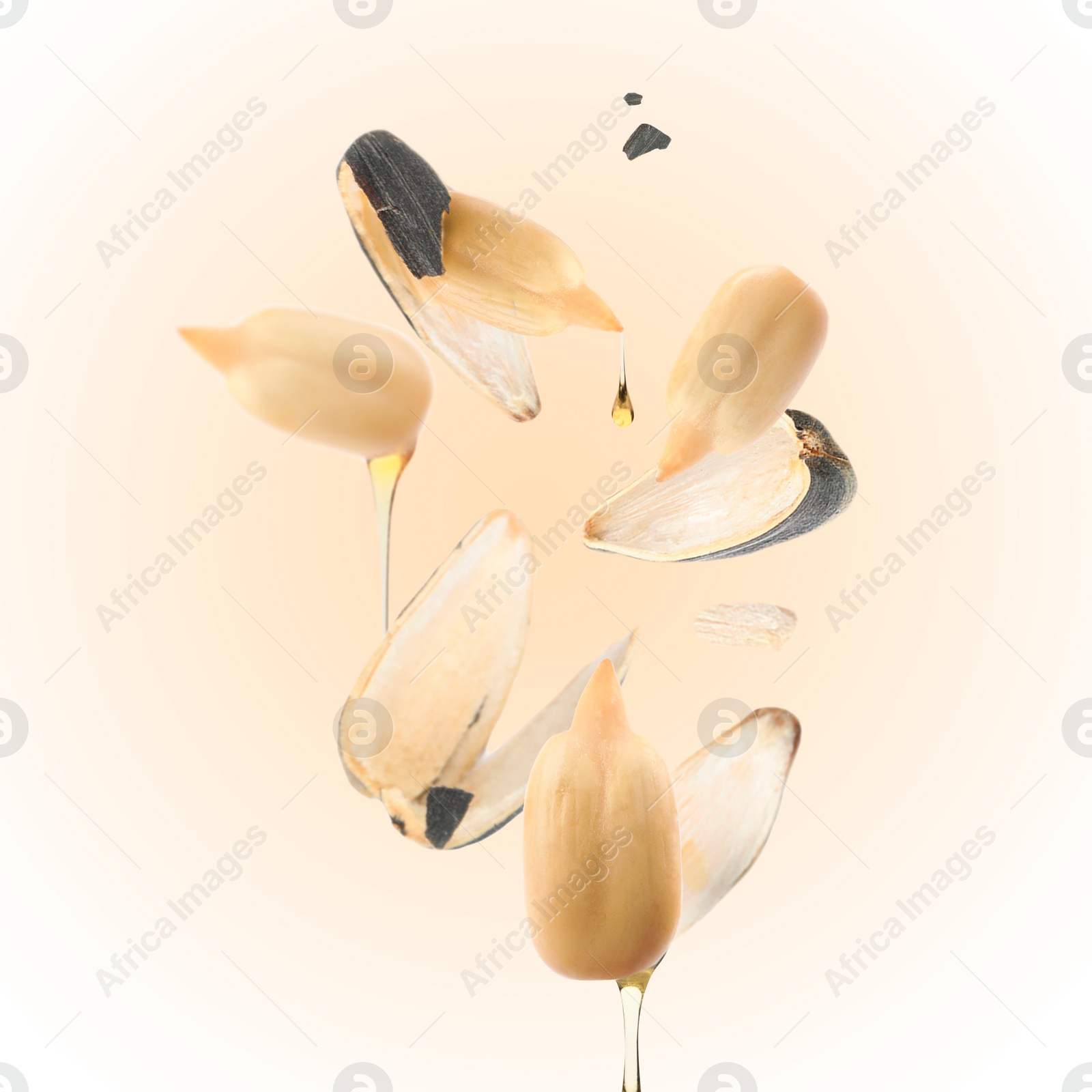 Image of Sunflower seeds with oil and husk on beige gradient background