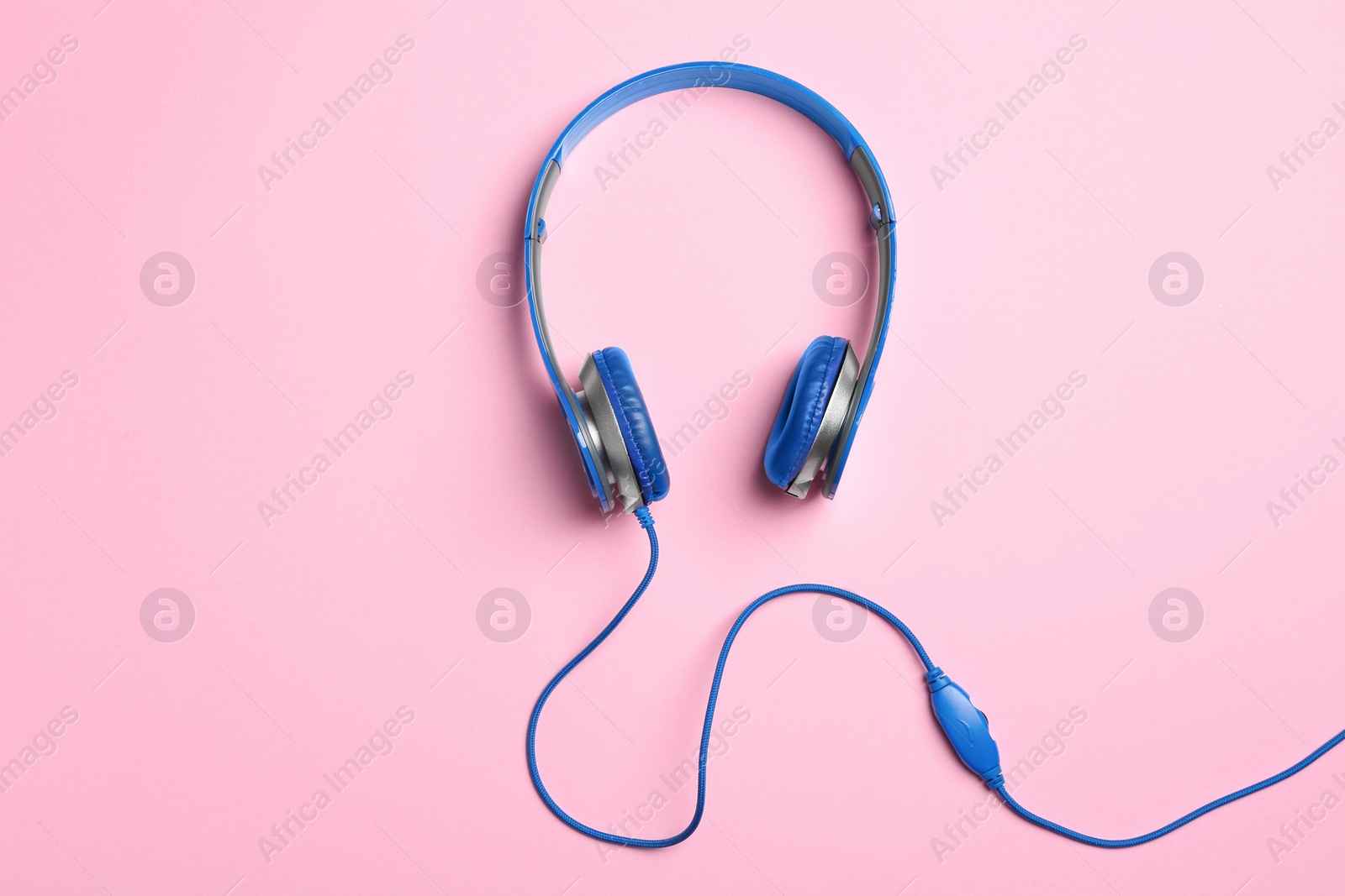 Photo of Stylish headphones on color background, top view