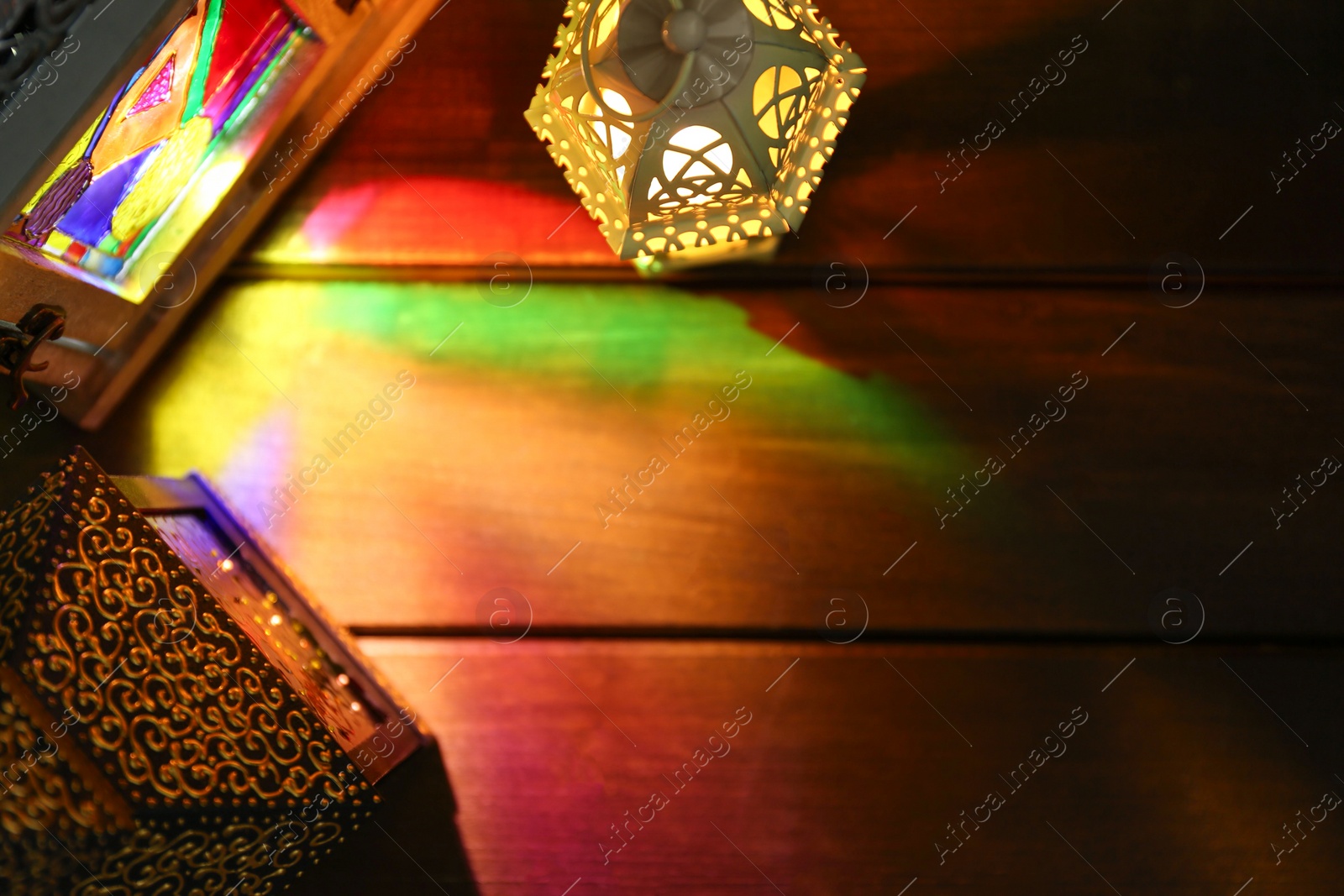 Photo of Decorative Arabic lanterns on wooden table, flat lay. Space for text