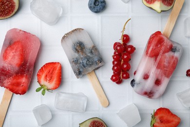 Photo of Flat lay composition with berry ice pops on light table