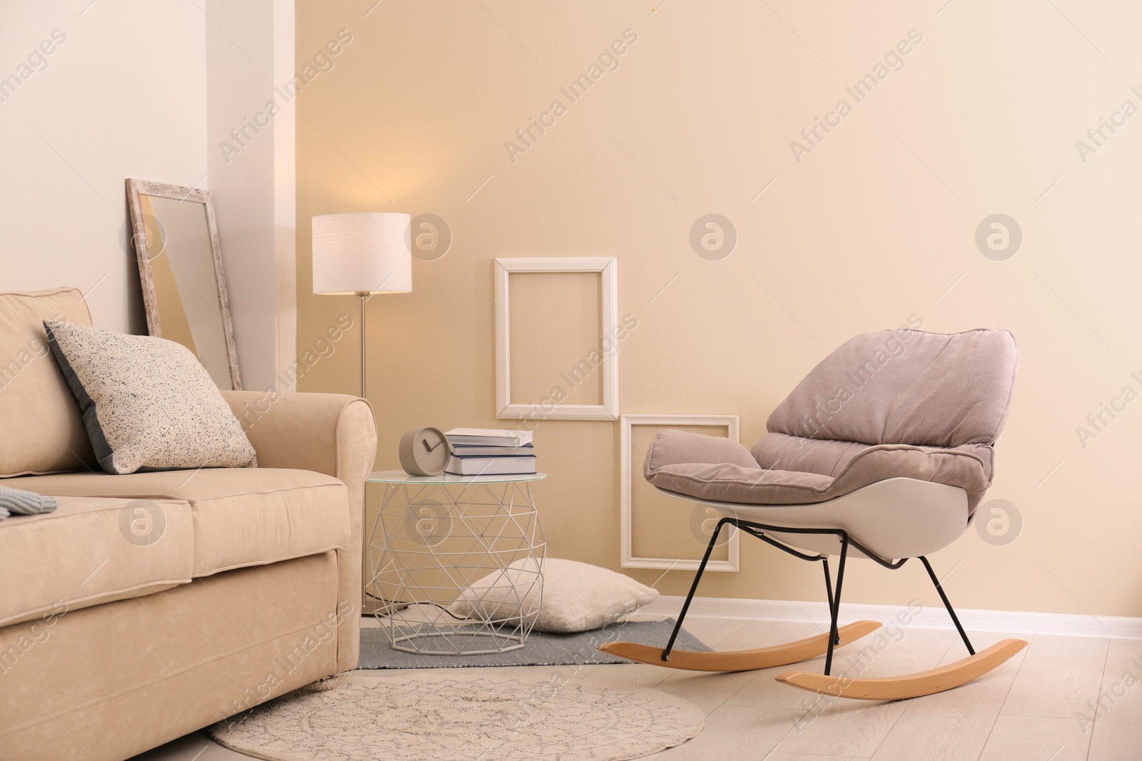 Photo of Modern living room interior with comfortable sofa and rocking chair