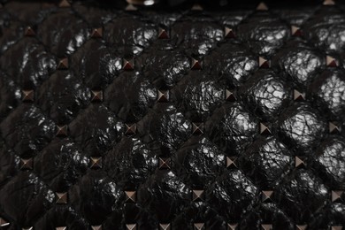 Photo of Texture of black leather bag as background, top view