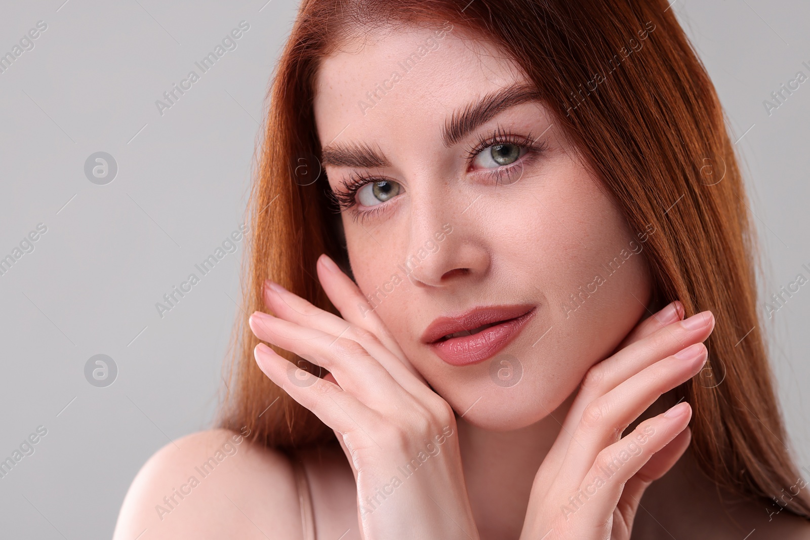 Photo of Portrait of beautiful woman on grey background, closeup