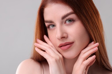 Portrait of beautiful woman on grey background, closeup