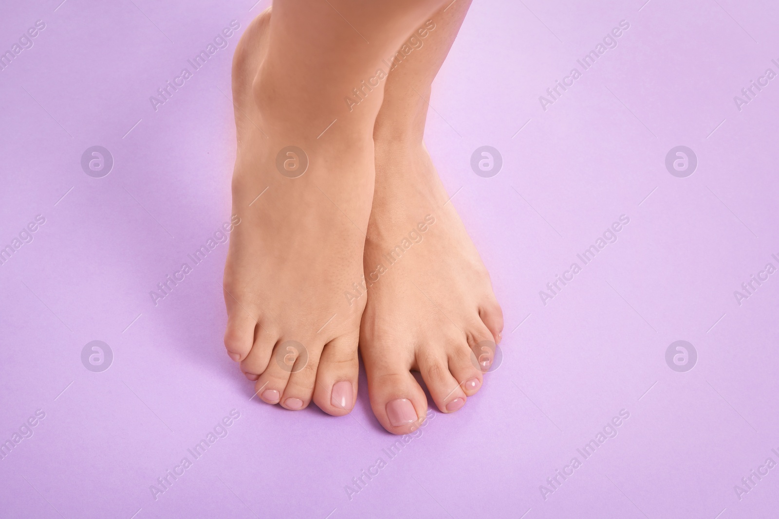 Photo of Woman with beautiful feet on color background, top view with space for text. Spa treatment