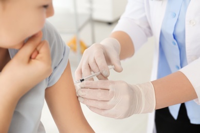 Photo of Doctor vaccinating little girl in hospital