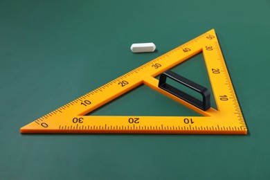 Photo of Yellow triangle and chalk on green chalkboard