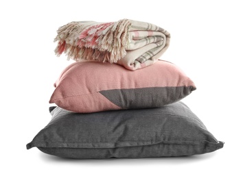 Photo of Stylish soft pillows and folded plaid on white background