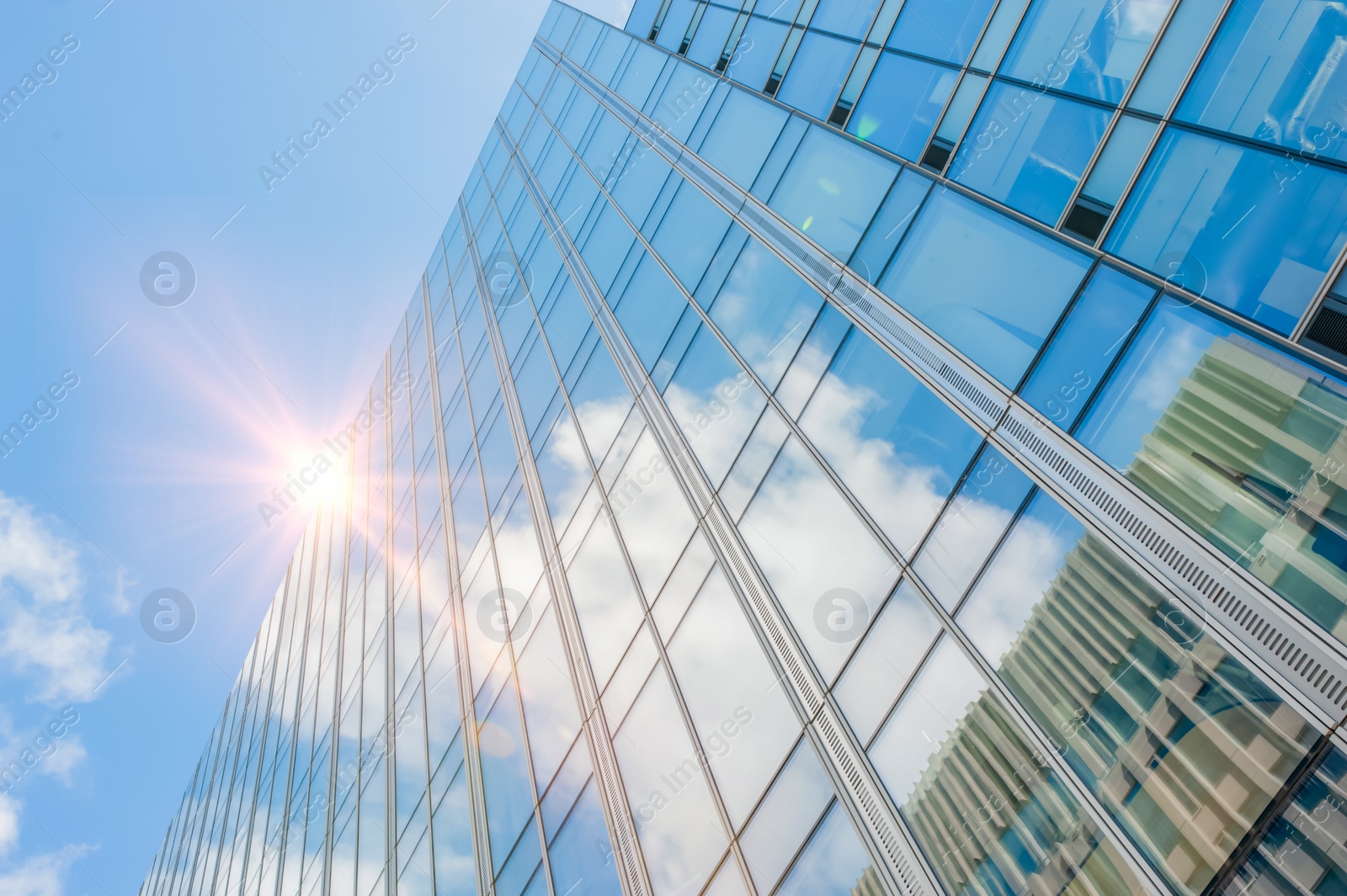 Photo of Beautiful building with many windows under cloudy sky, low angle view