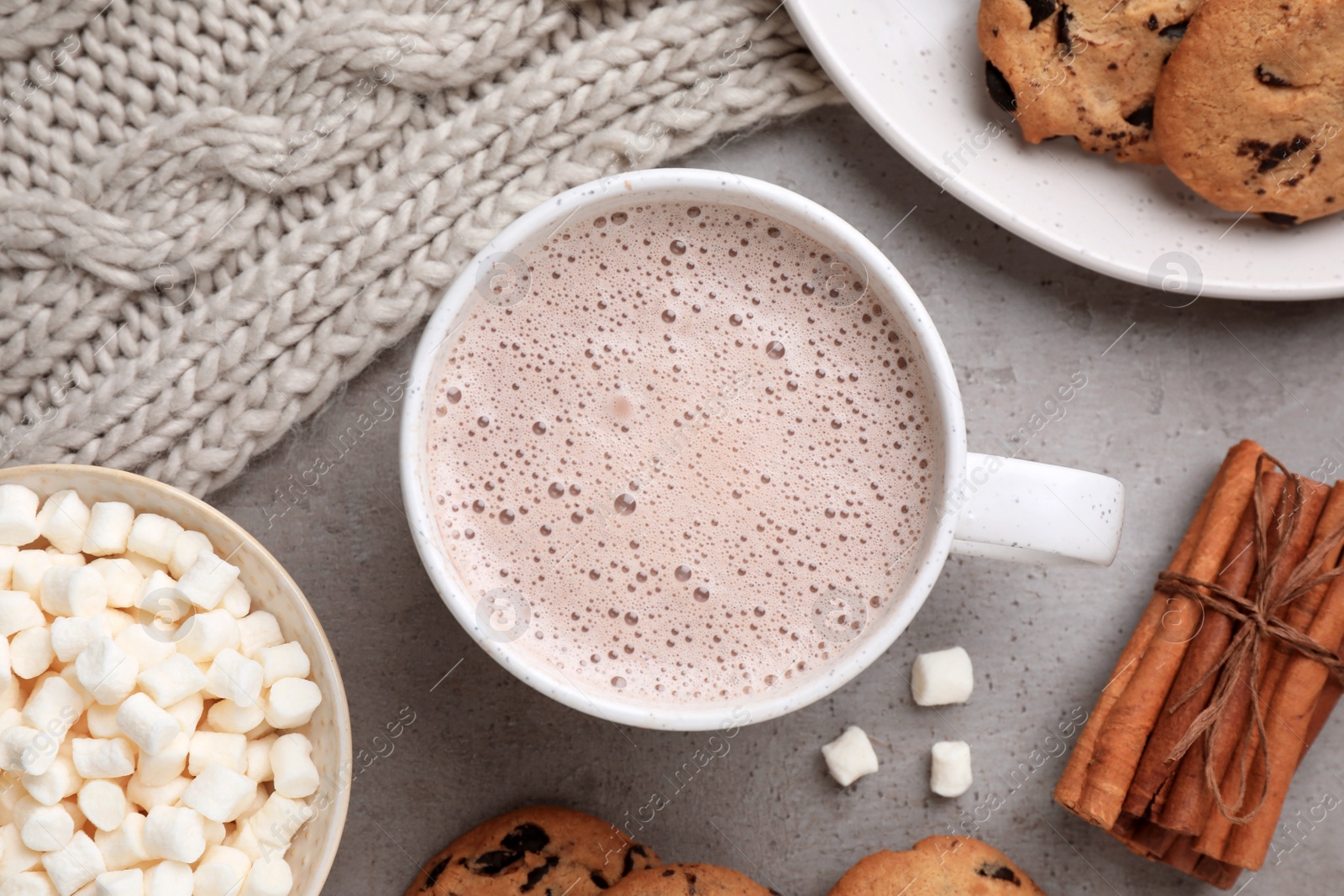 Photo of Flat lay composition with cup of delicious hot cocoa on grey table