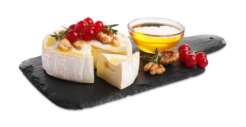 Photo of Brie cheese served with red currants, walnuts and honey isolated on white