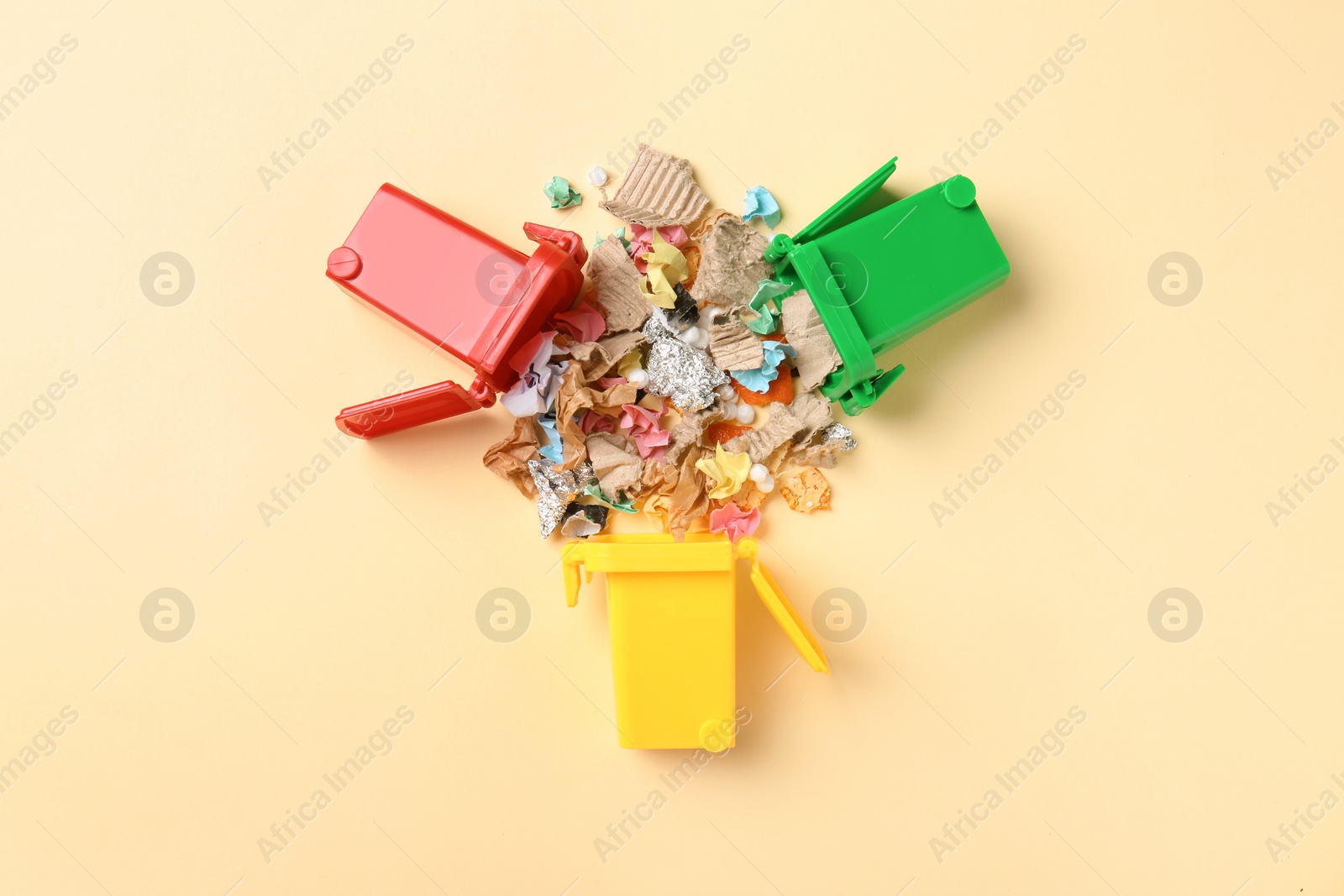 Photo of Trash bins and different garbage on color background, top view. Waste recycling concept