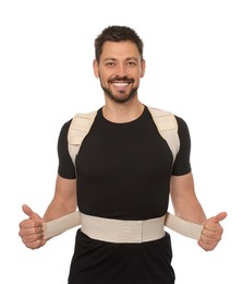 Photo of Handsome man with orthopedic corset on white background