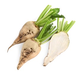 Whole and cut sugar beets on white background, top view