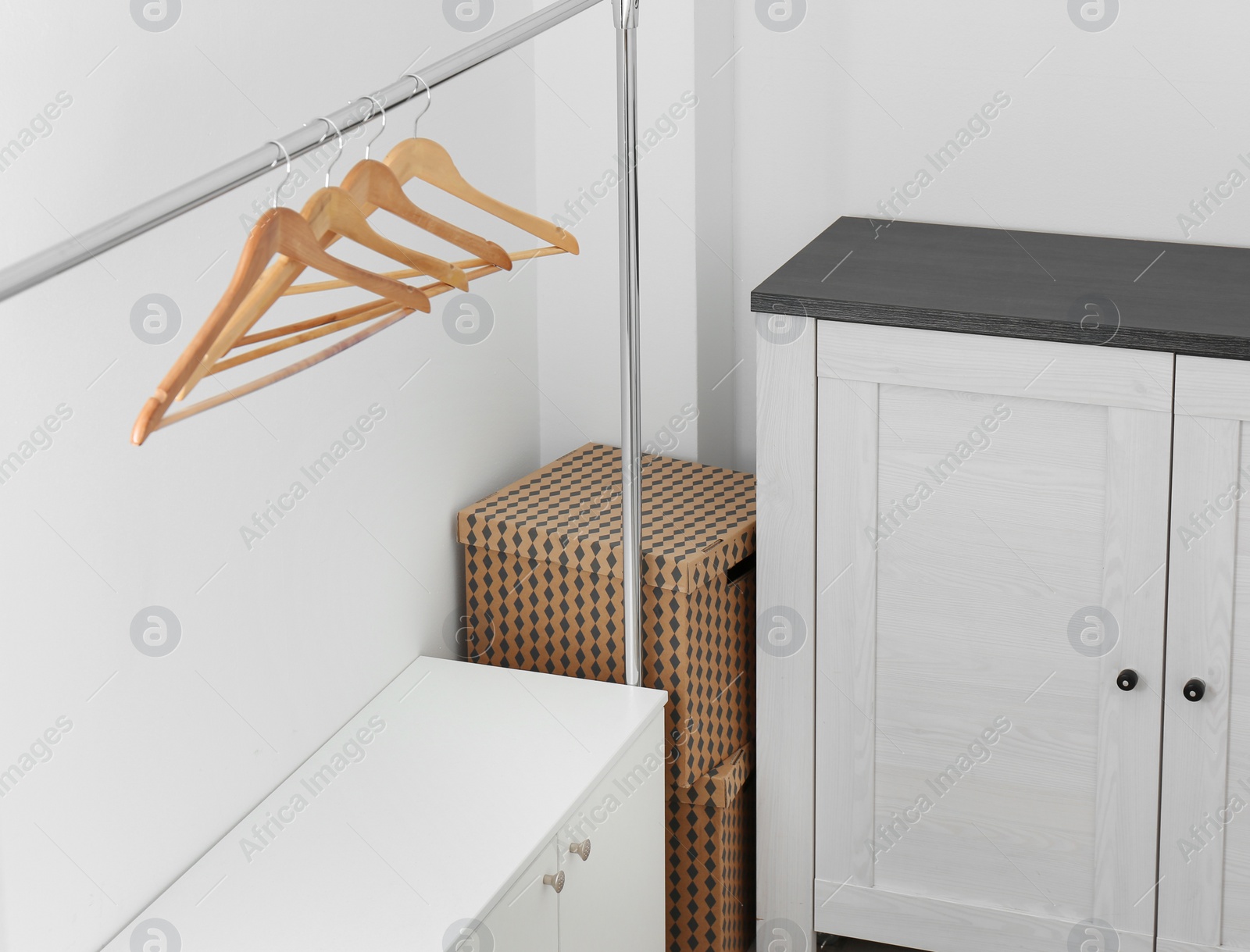 Photo of Modern dressing room interior with furniture and hangers