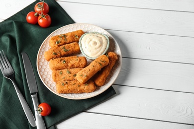 Photo of Plate of cheese sticks and sauce served on table, top view. Space for text