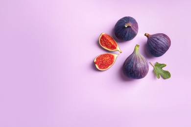 Photo of Fresh ripe figs on light background, top view. Space for text