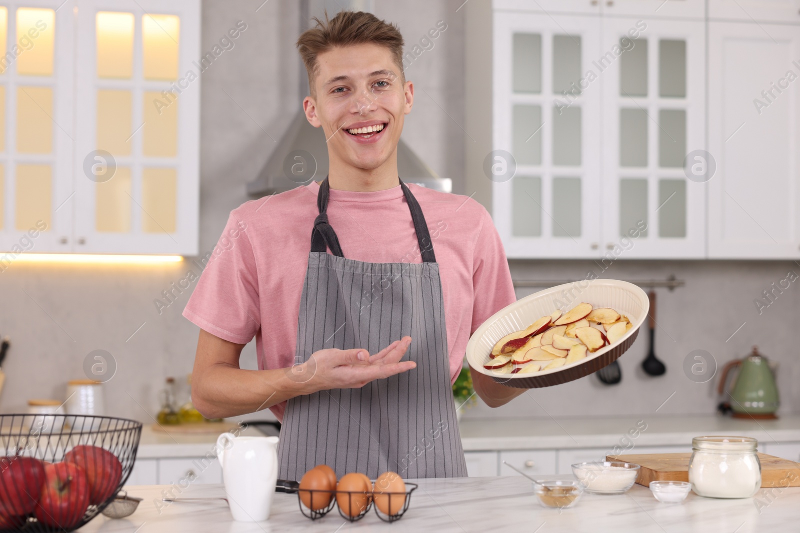 Photo of Smiling food blogger explaining something in kitchen