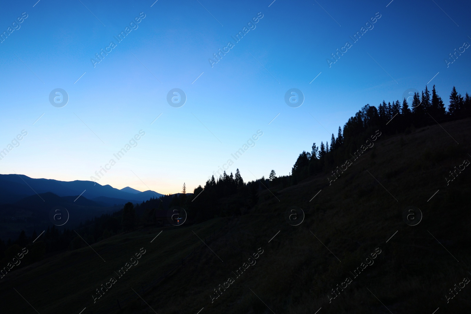 Photo of Silhouette of mountains against beautiful sky at night