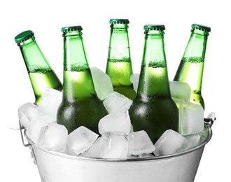 Metal bucket with bottles of beer and ice cubes on white background