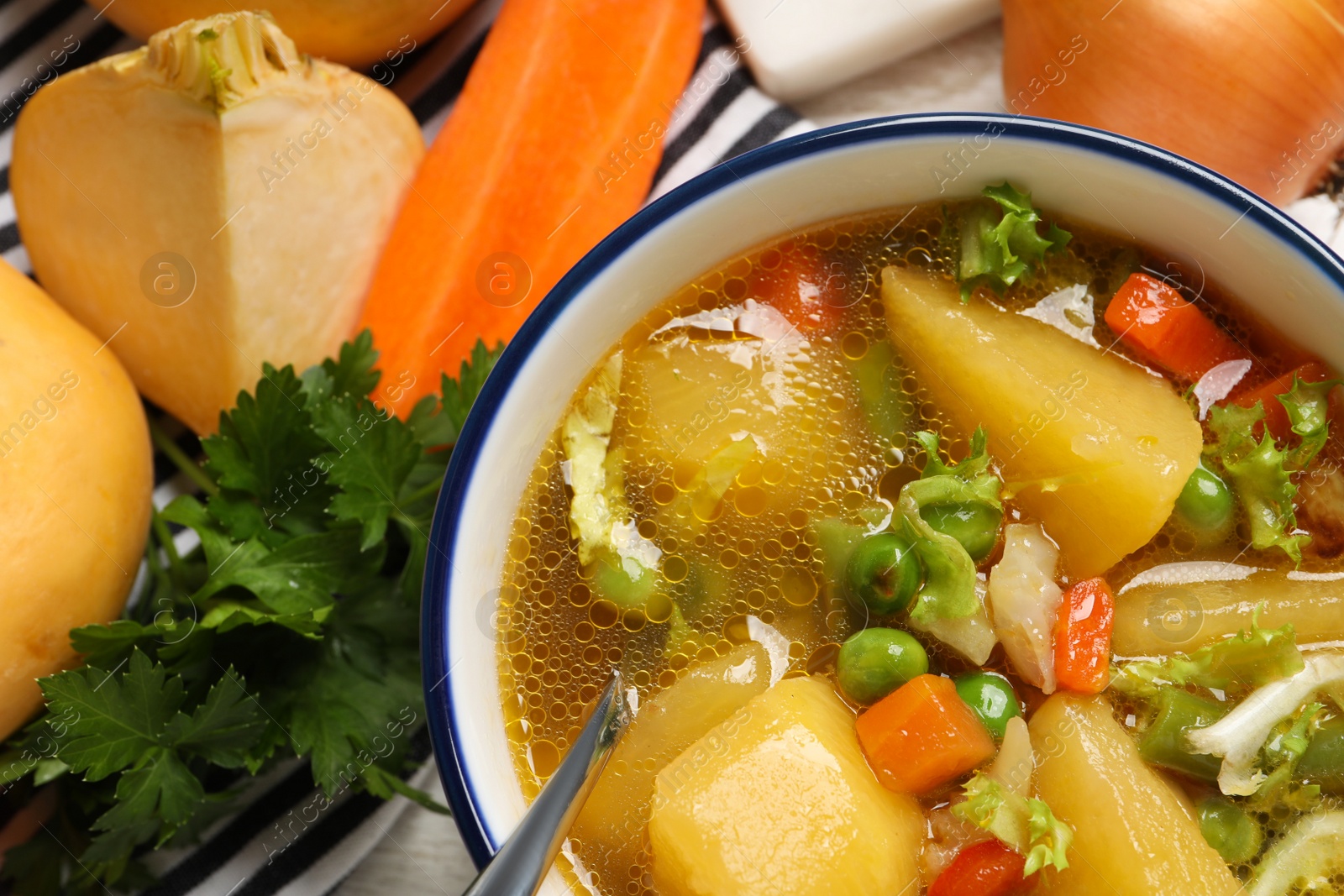 Photo of Bowl of delicious turnip soup on table, flat lay