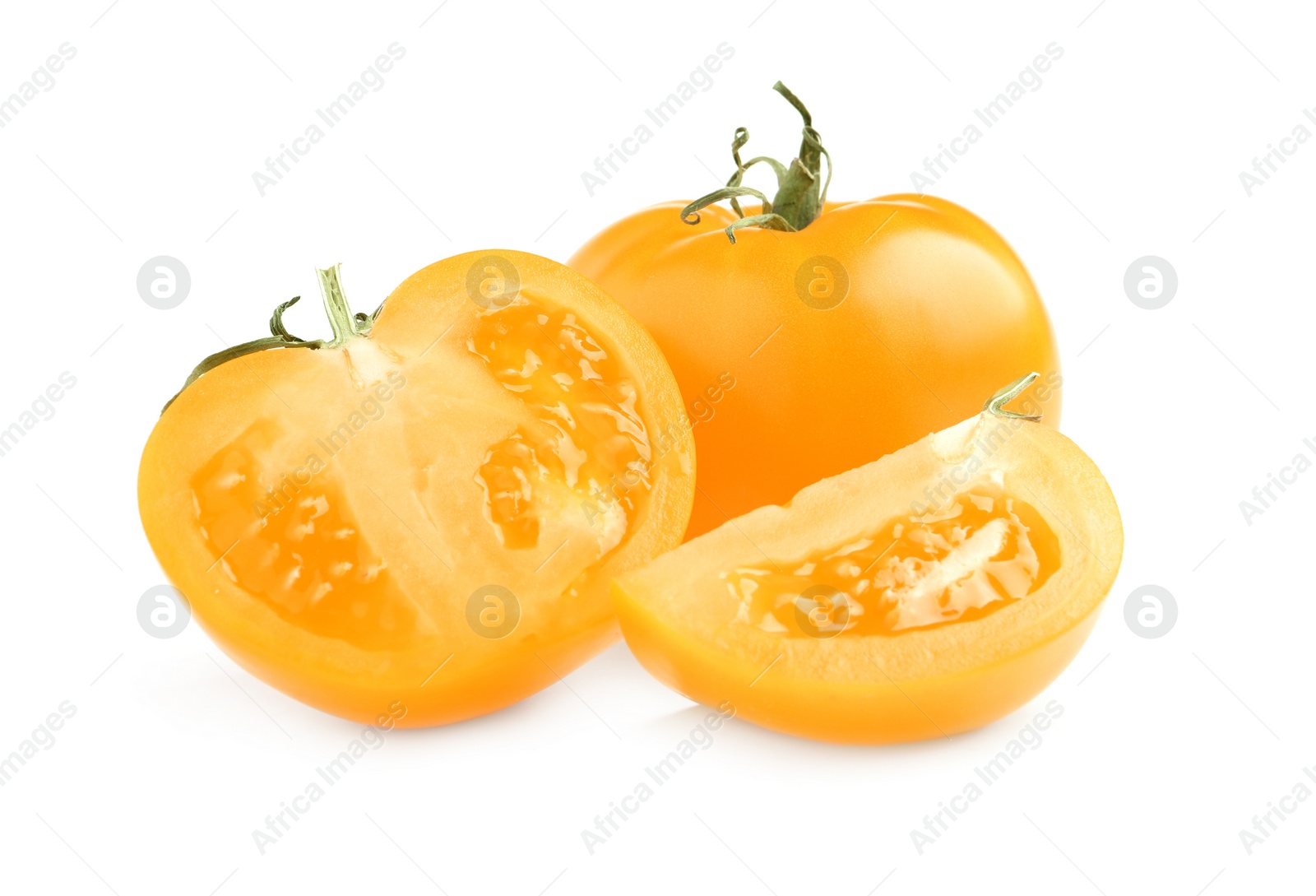 Photo of Cut and whole yellow tomatoes on white background