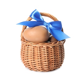 Photo of Delicious chocolate Easter eggs in wicker basket isolated on white