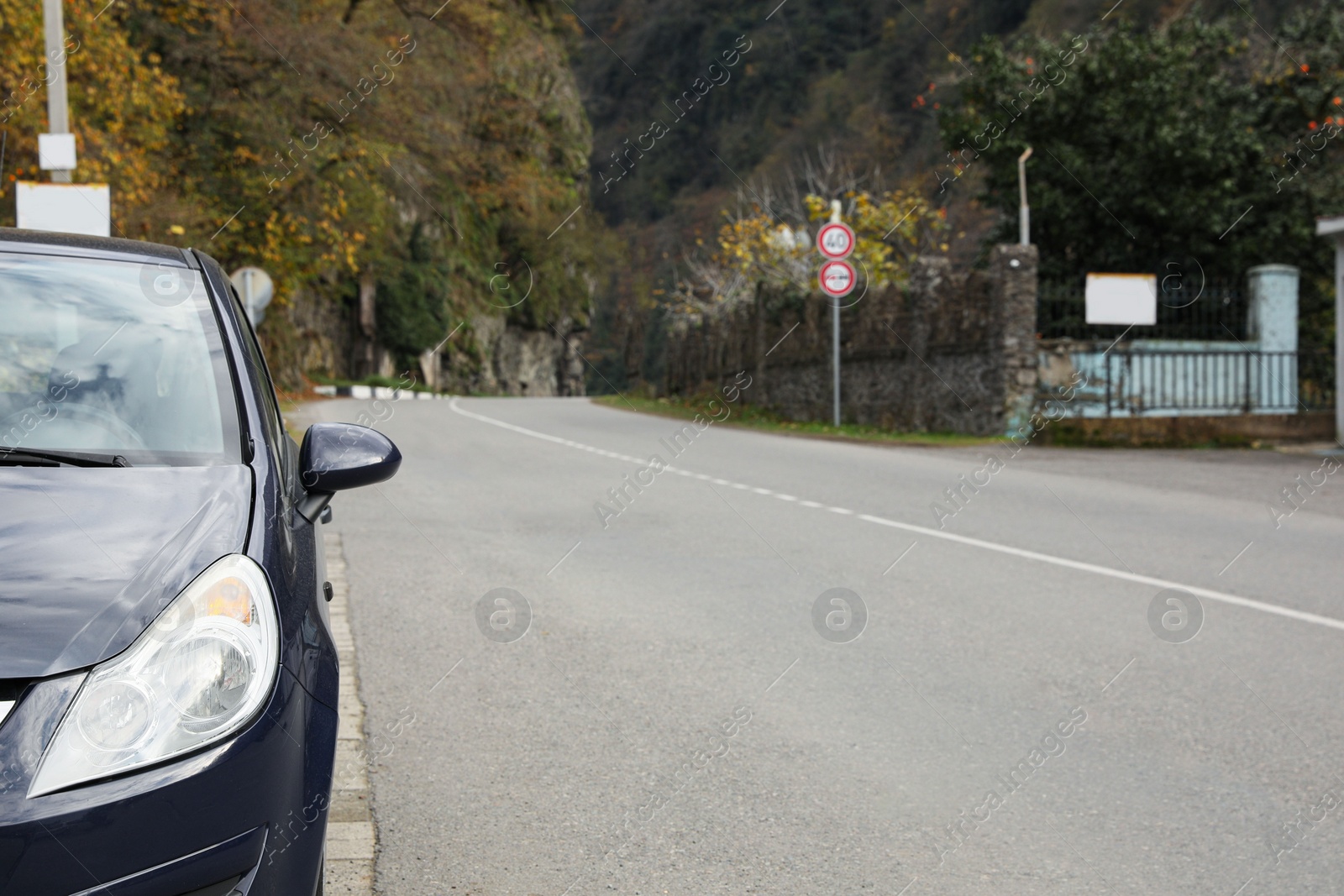 Photo of Black car parked near road in mountains