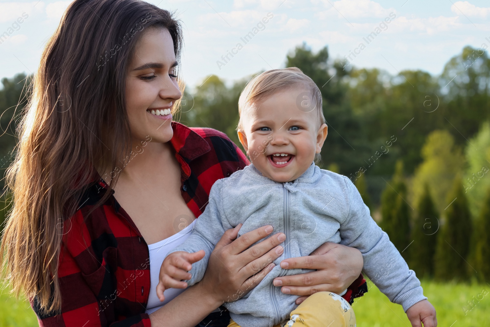 Photo of Happy mother with her cute baby in park on sunny day