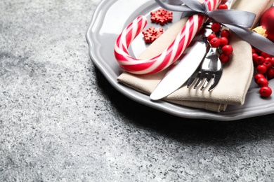 Photo of Beautiful Christmas table setting on grey background. Space for text