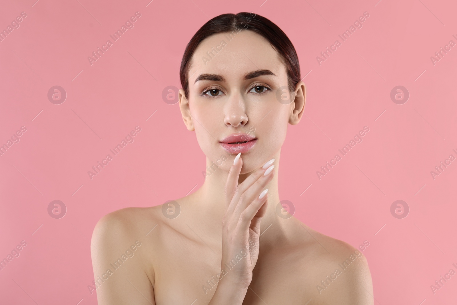 Photo of Portrait of beautiful young woman on pink background