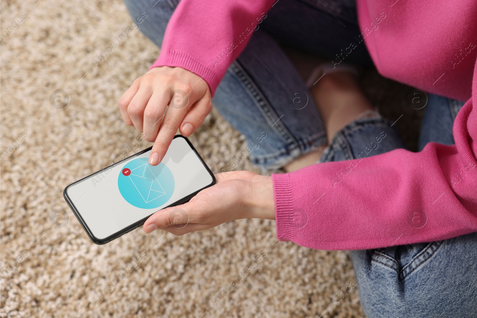 Image of Woman checking new message on mobile phone indoors, closeup