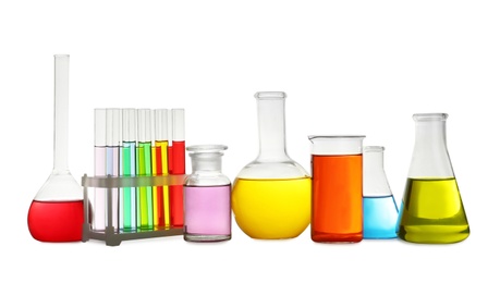 Laboratory glassware with colorful liquids on white background