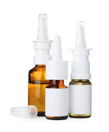 Photo of Many different nasal sprays on white background