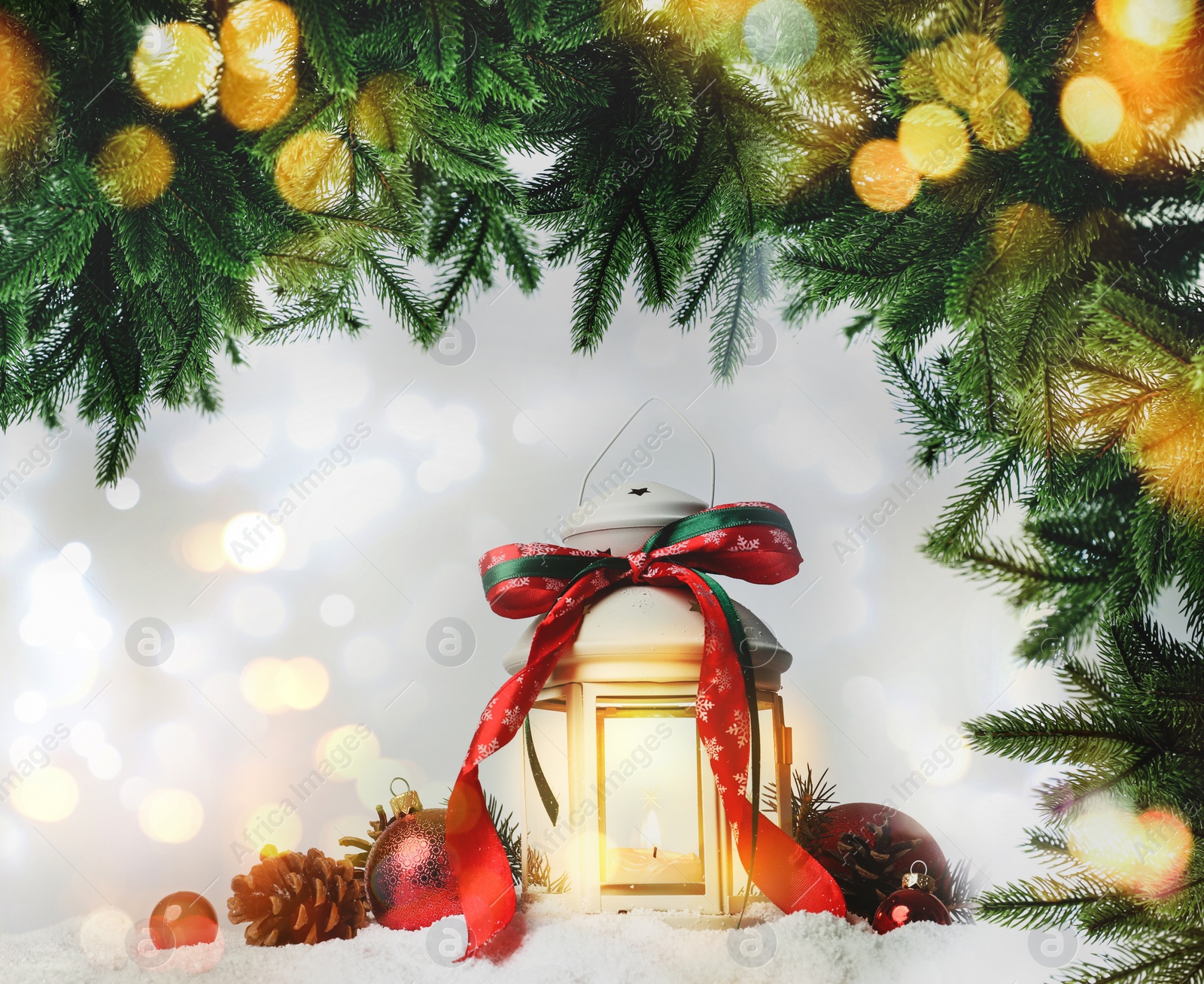 Image of Beautiful composition with vintage Christmas lantern and festive decorations on snow against color background. Bokeh effect