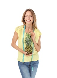 Photo of Happy slim woman with measuring tape and pineapple on white background. Positive weight loss diet results