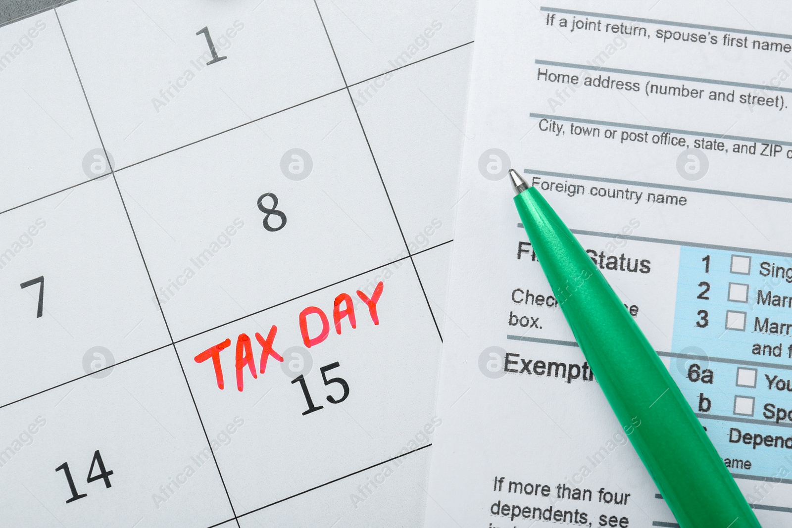 Photo of Tax day. Document and pen on calendar with date reminder, flat lay