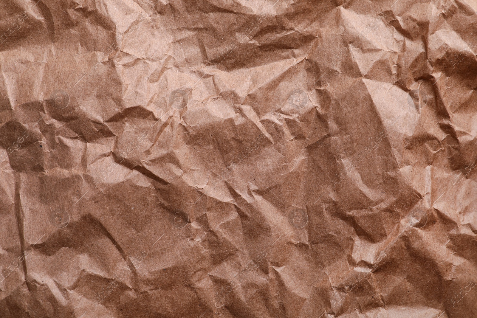 Photo of Texture of wrinkled kraft paper bag as background, closeup