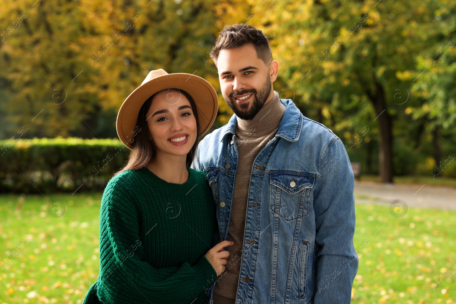 Photo of Happy young couple spending time together in autumn park