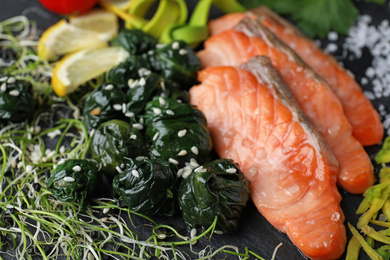 Photo of Tasty freshly cooked salmon with spinach, closeup