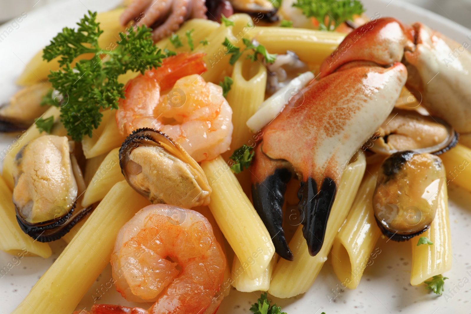 Photo of Delicious pasta with sea food in plate, closeup