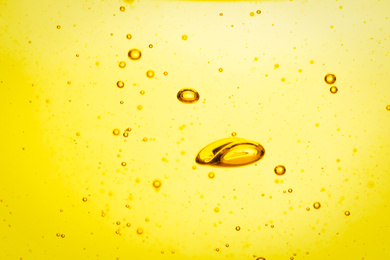 Cooking oil with bubbles as background, closeup